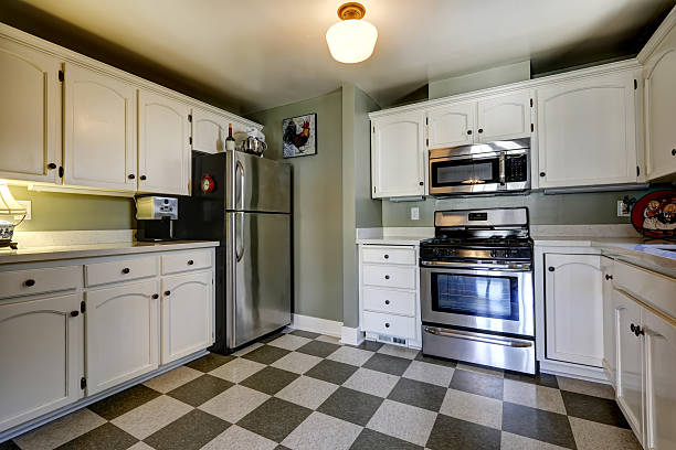 istock White kitchen cabinets and steel appliances. 517253159