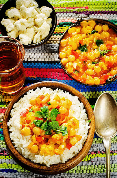 istock rice with curry chickpeas with vegetables and Arabic flat bread with herbs 517253181