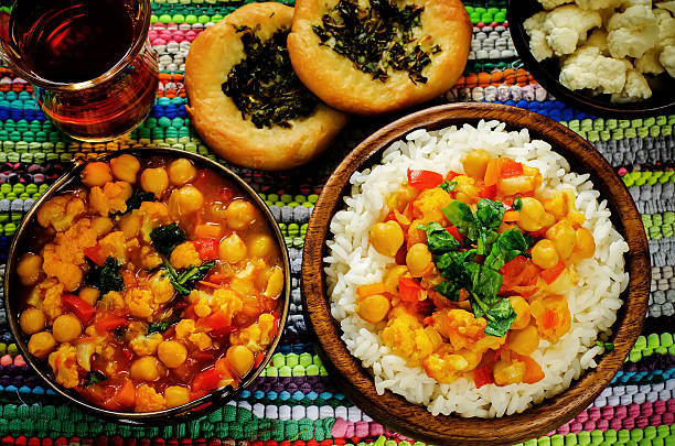 istock rice with curry chickpeas with vegetables and Arabic flat bread with herbs 517253187