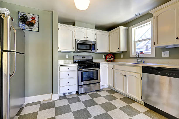istock White kitchen cabinets and steel appliances. 517253723