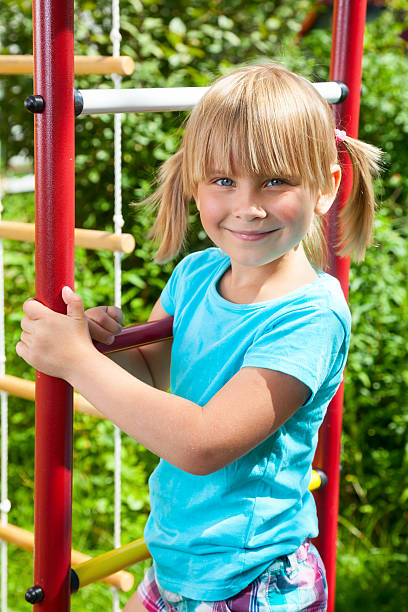 istock Happy girl on a jungle gym 517254929
