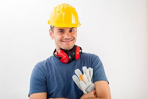 istock Workman wearing a yellow hard hat and full protective gear 517255243