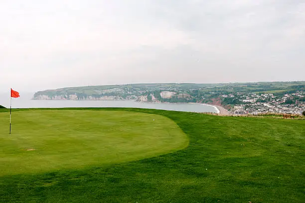 The 12th green overlooking  the sea on a beautiful coastal links golf course in Devon, Axe Cliff Golf Club, Axmouth, Devon