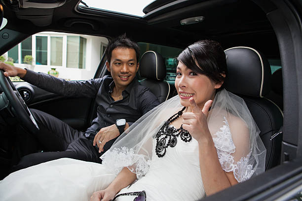 istock gorgeous wedding couple in car 517268565