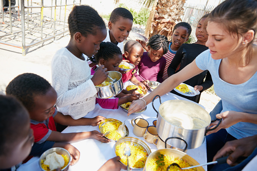 Cropped shot of children getting fed at a food outreach
