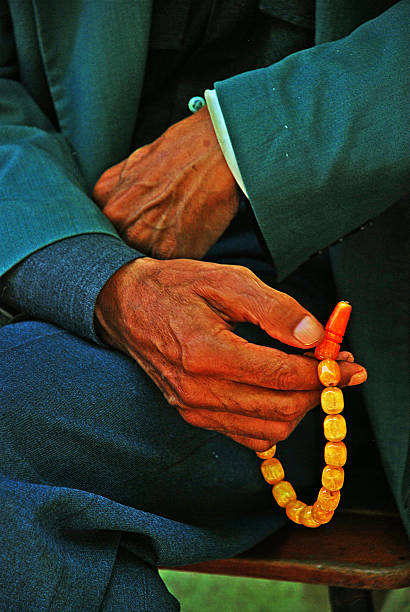 istock Old man hand and prayer beads 517269394