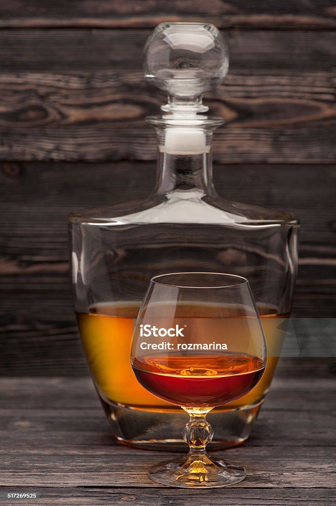 Cognac bottle and glass Cognac bottle and glass on wooden background Alcohol - Drink Stock Photo
