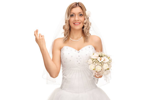 istock Young bride holding her fingers crossed 517269716