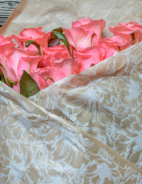 istock Bouquet of gift wrapped pink roses 517273632