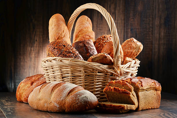 композиция с различные выпечки продукты на деревянном столе - bread bread basket basket whole wheat стоковые фото и изображения