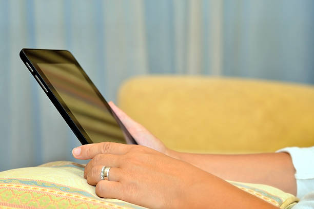 istock Close up image of woman hands holding tablet device 517275394