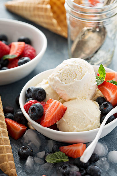 istock Vanilla ice cream scoops with berries 517275628
