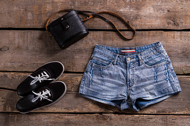 istock Woman's denim shorts with handbag. 517276130