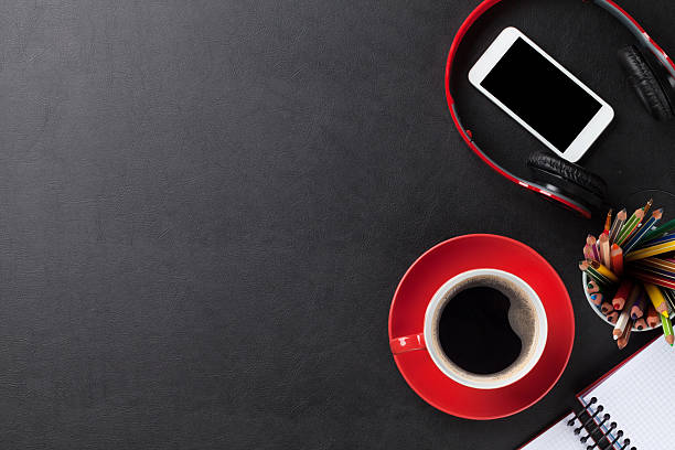 istock Desk with notepad, coffee, smartphone and headphones 517278566