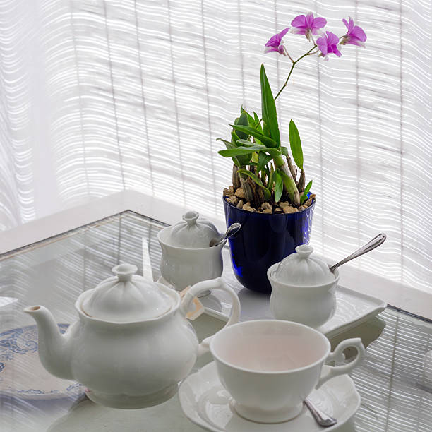 Ceramic utensils on table with flower decoration