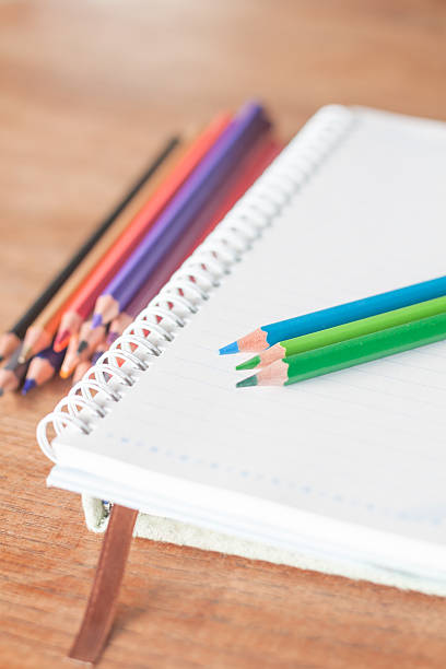 istock Colorful pencils on spiral notebook and green notebook 517283445