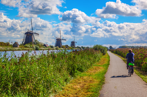 Kinderdijk, Netherlands - September 04, 2015: windmills with unidentified people in Kinderdijk. The place is one of the best-known Dutch tourist sites and UNESCO World Heritage Site since 1997