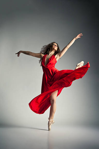istock Ballet dancer wearing red dress over grey 517300292
