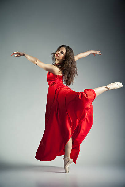 istock Ballet dancer wearing red dress over grey 517300462