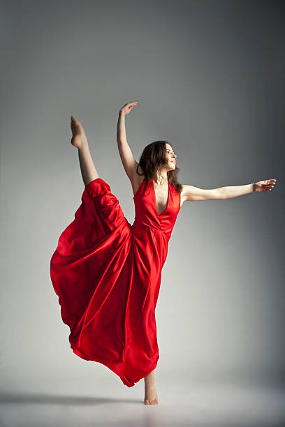 istock Ballet dancer wearing red dress over grey 517300922