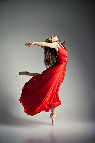 istock Ballet dancer wearing red dress over grey 517301040