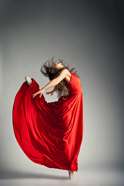istock Ballet dancer wearing red dress over grey 517301148