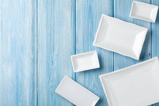 istock Empty plates and bowls on blue wooden background 517301796