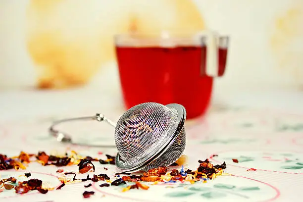 Tea and Tea Strainer with forest fruit herbal tea.