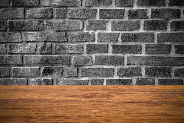 istock Wood table top on Brick wall for background 517302776
