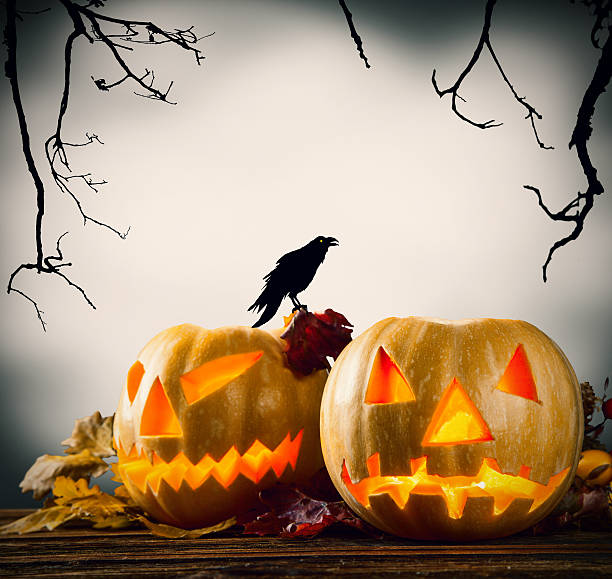 istock Halloween pumpkins on wood with dark background 517304761