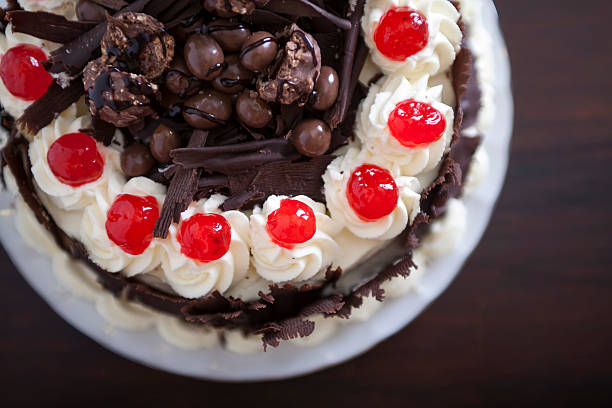 istock chocolate cake with cream and cherries. 517306087