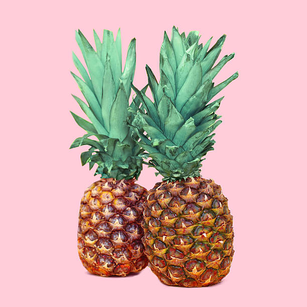 istock Two pineapple on colorful pink background, ananas concept 517307574