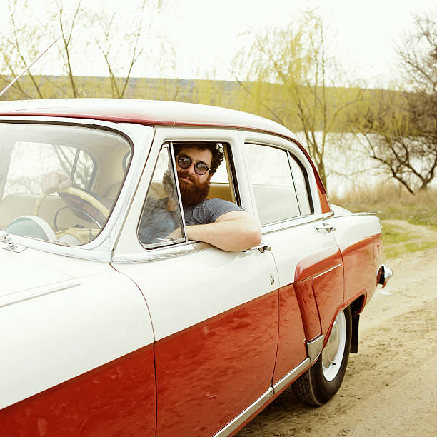 istock Bearded man behind the wheel of a retro car 517307724