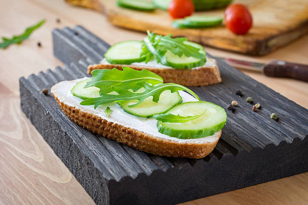 istock Snack toast with cream cheese, cucumber and arugula 517308214