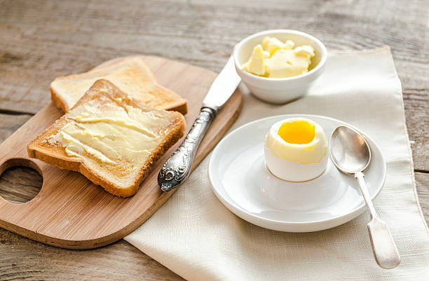 istock Boiled egg with crispy toasts on the wooden table 517308539
