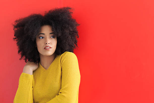 istock Young woman posing on red background 517309032
