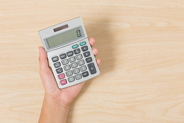 istock Hand hold Calculator on Wood Background 517309598