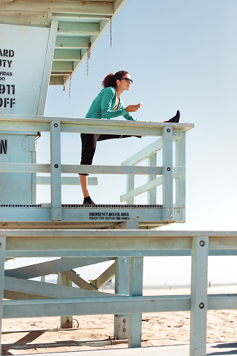 istock Woman exercising in LA, Venice Beach, California 517311388