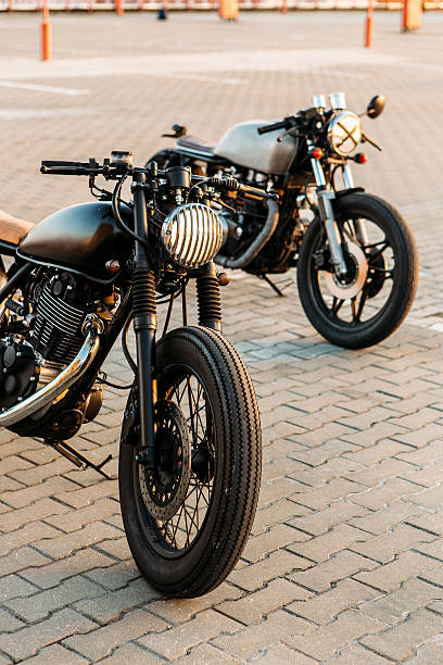 istock Two black and silver vintage custom motorcycles caferacers 517313070