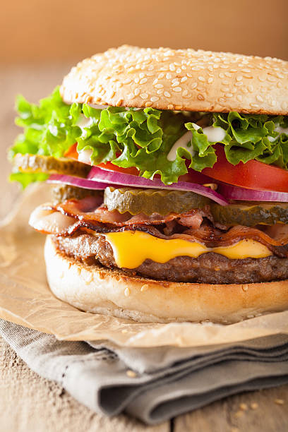 istock bacon cheese burger with pickles tomato onion 517313110