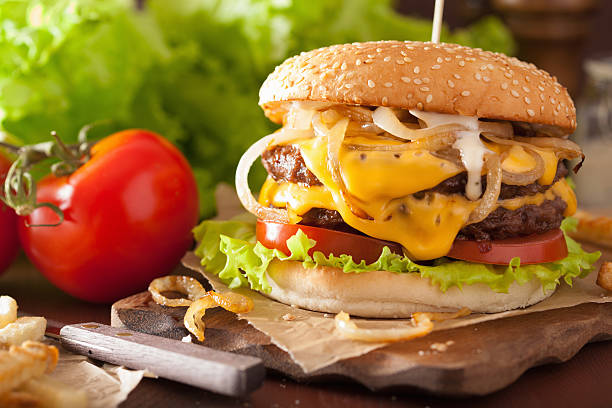 istock double cheeseburger with tomato and onion 517313360