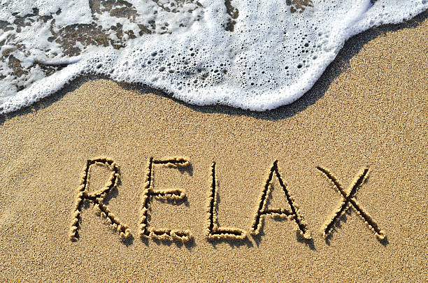 istock Sea surf and the word relax on the sand 517313536