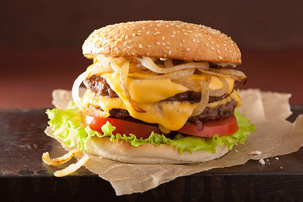 istock double cheeseburger with tomato and onion 517313544