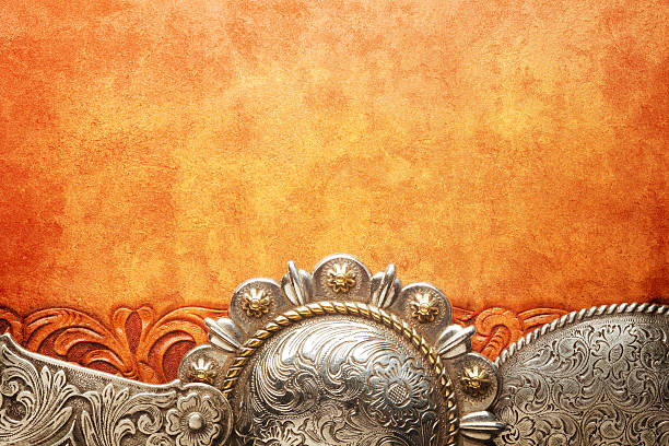 istock Western Style Belt Buckles On Tooled Leather Surface 517313788