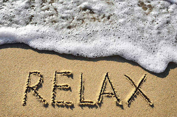 istock Sea surf and the word relax on the sand 517313822