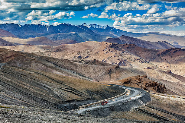 Indian lorry truck on road in Himalayas mountains Indian lorry truck on road in Himalayas near Tanglang la Pass  - Himalayan mountain pass on the Leh-Manali highway. Ladakh, India ladakh region photos stock pictures, royalty-free photos & images