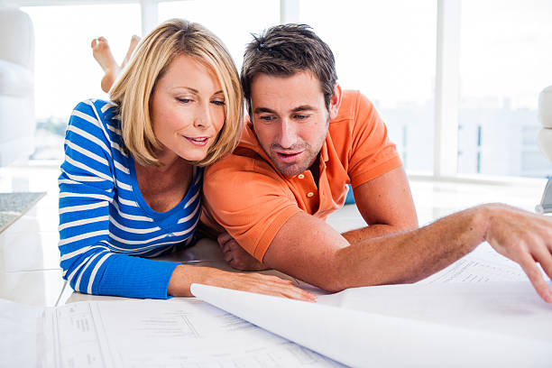 istock Caucasian couple discussing blueprints 517321689