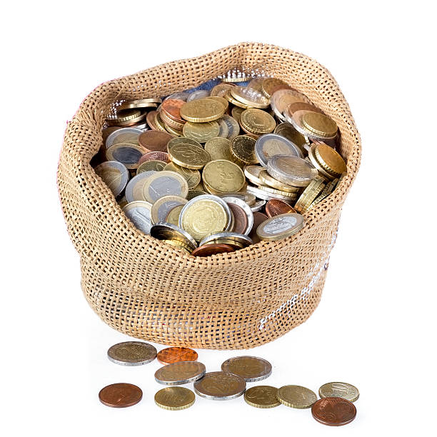 istock Money bag with coins isolated over white 517323781