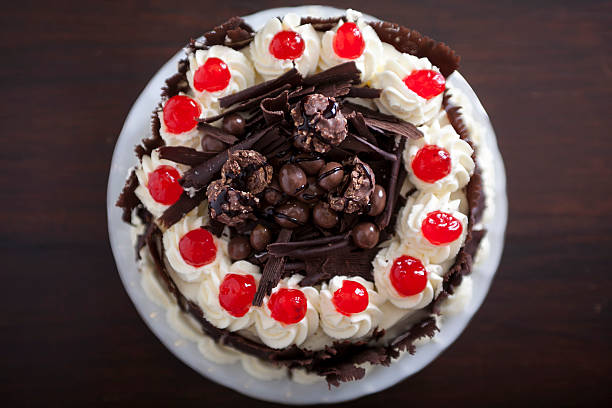 istock Chocolate cake with cream and cherries, from above. 517324627