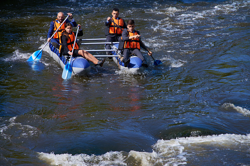 Strong business team practicing rafting